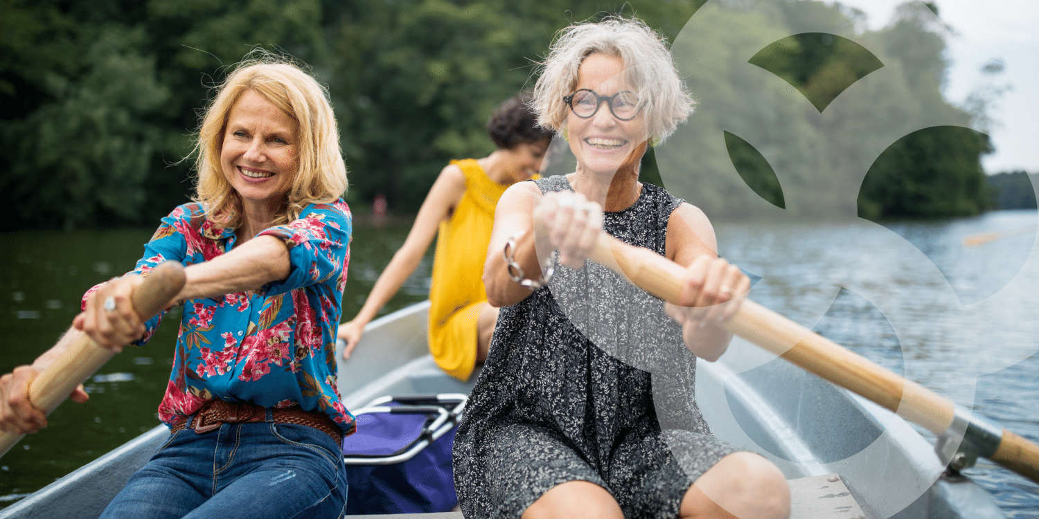 Older women rowing boat happily
